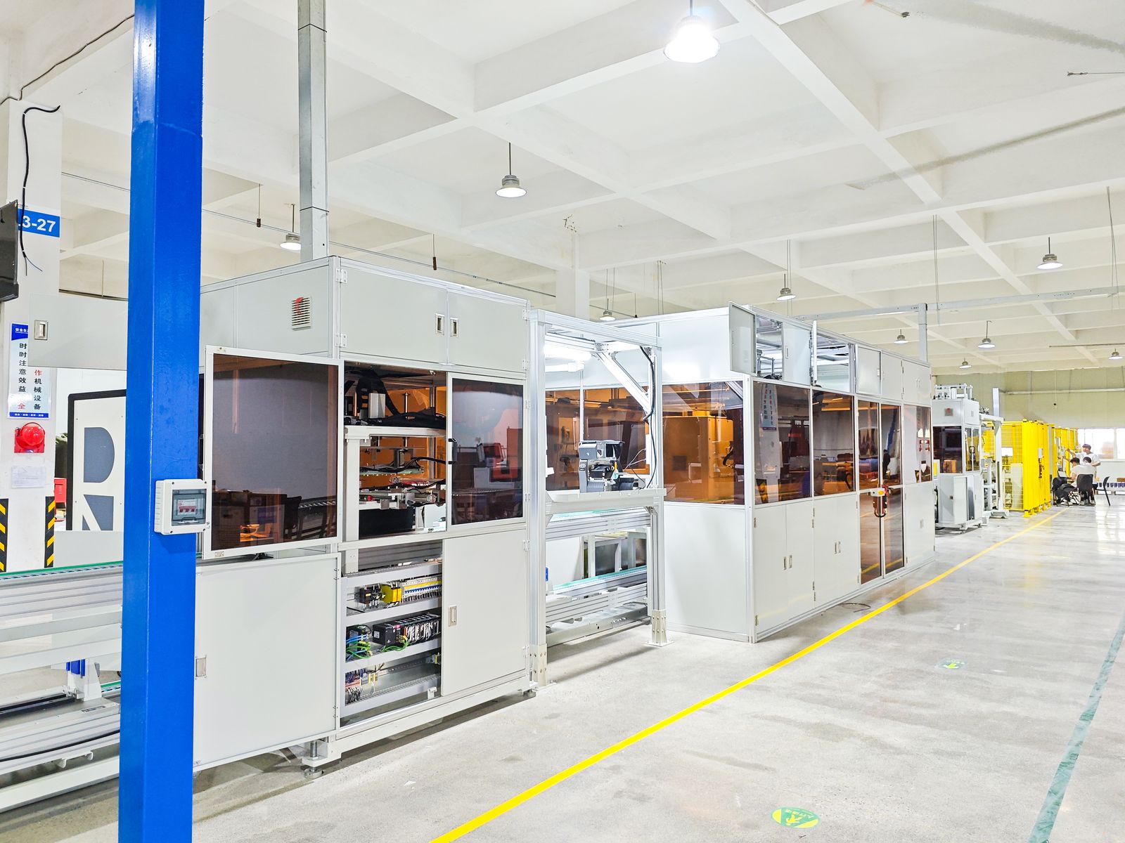 Automated assembly line 1 with enclosed welding stations and conveyor