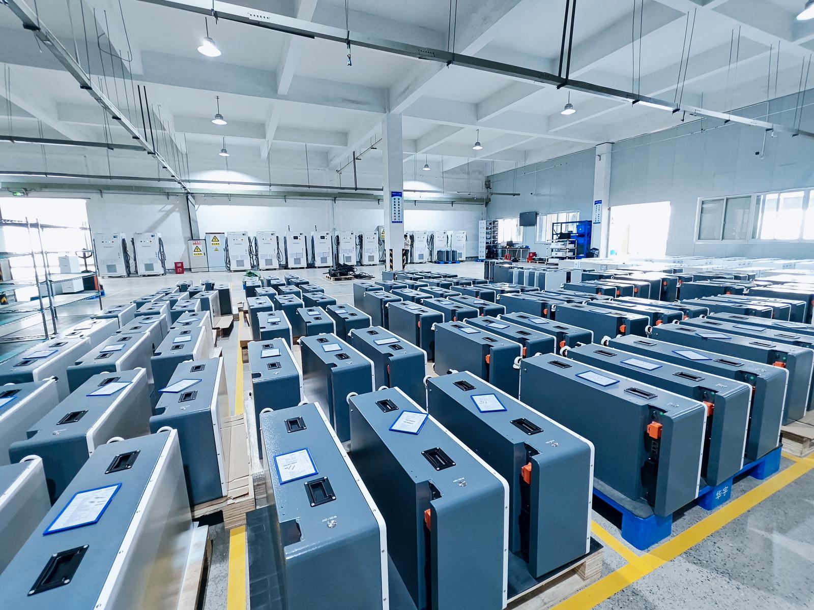 Finished battery packs staged in rows on the factory floor